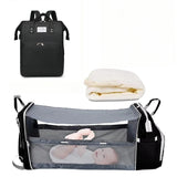 Sac à langer noir avec lit d’appoint bébé